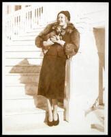 Sepia-tone photograph of Marion Davies with her pet dog Gandhi