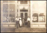 Photograph of the "Cozy Saloon" with a display window poster advertising for "Daniel Boone on the Trail" tour from the Geyer Bros. Railroad Shows