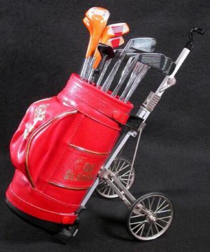 Complete set of 14 golf clubs with a red leather caddie bag on wheels, plus 4 miniature golf balls