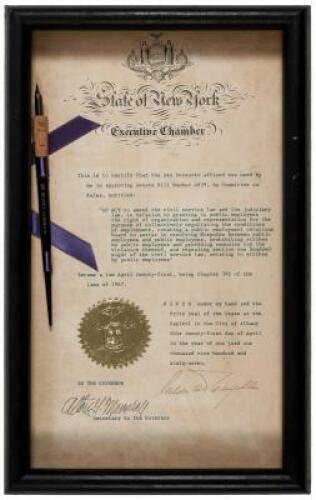 Document signed, with pen used to sign a Senate bill attached