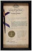 Document signed, with pen used to sign a Senate bill attached