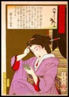 Five o'clock in the afternoon. Geisha with a mirror adjusting her hair