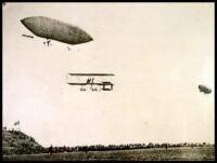 Photograph of an early biplane and manned dirigible