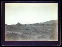 Two albumen photographs of large cannon being fired from earth breastworks