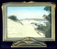 Original hand-tinted color photograph in a standing frame in the Art Nouveau style showing a California coastal scene