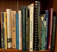 Shelf lot of photography instructional volumes