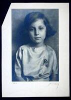 Silver photograph of a young girl wearing a dress with a flower embroidered in it