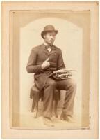 Cabinet-size photograph of a well-dressed Black musician holding a Cornet