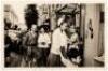 Original photograph of Josephine Baker shopping in a French resort town with one of her 12 adopted children