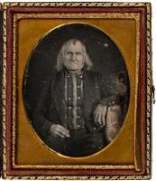 Daguerretype of an elderly man with straggly white hair, wearing at jacket with a double-row of buttons, seated in a studio