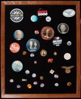 Approximately 35 campaign buttons from U.S. presidential campaigns from Garfield to McCain, in glass & wood display case