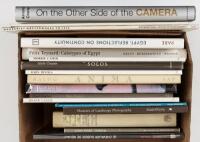 Shelf of books on photography, including Man Ray, Arnold Crane et al.
