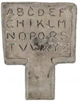 Hornbook of cement(?) with alphabet carved on one side, the other with cast metal plaque with figures surrounded by lettering