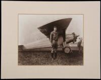 Gelatin silver photograph of Charles Lindbergh standing under the wink of the Spirit of St. Louis