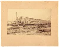 Photograph showing the building of a steamship on the banks of the Columbia River