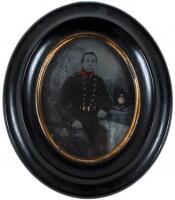 Tintype of a German policeman in uniform, seated in a studio with his helmet on the table beside him