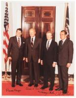 Color photographic print of Presidents Reagan, Ford, Carter and Nixon, standing in front of a U.S. and a presidential flag, signed by each of them in ink beneath their images