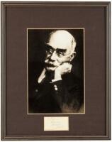 Signature of Rudyard Kipling on slip of paper, matted with a portrait