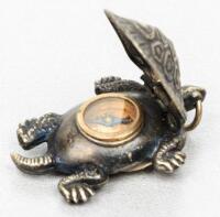 Silver minature turtle with compass under carapace