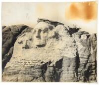 Original photograph of a partially completed Mount Rushmore, inscribed by artist and sculptor Gutzon Borblum to Senator Reed Smoot of Utah, who helped obtain Congressional funding for the project