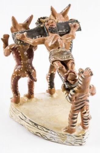 Mexican ceramic sculpture of a crucified Christ being carried on the shoulders of two wolf-like figures and one lizard like figure.