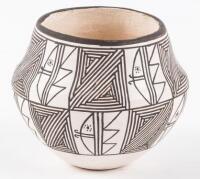 Small white pot with intricate design in black