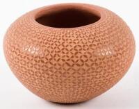 Small red pot with carved design