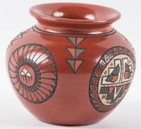 Red pot with flared rim with painted and carved designs