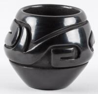 Small black pot with deeply carved design