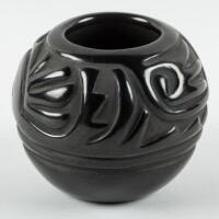 Small black pot with deeply incised design