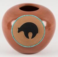 Red pot with black bear design and inlaid turquoise circle