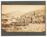 Original albumen photograph of two 20-mule teams pulling wagons laden with borax