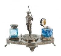 Silver plate pen holder and ink stand with figure of a golfer.