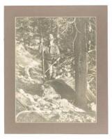 Original photograph of Saxton Pope standing over a grizzly bear he had just shot with a bow and arrow, both of which he holds