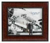 Signed photograph of Paul Tibbets standing in front of the Enola Gay