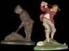 Two cast iron door stops with golfing figures