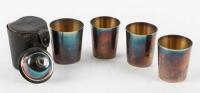 Set of four nesting silver-plate cups with engraved golfing scenes