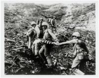 Signed photograph of soldiers starting to climb Mt. Suribachi with the American flag - signed by Charles W. Lindberg