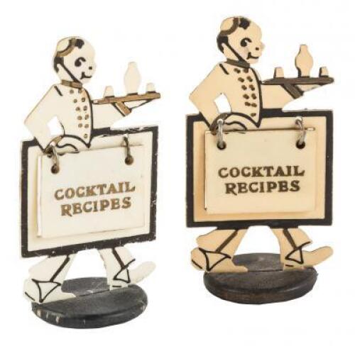 Two bakelite figures bearing cocktail recipes