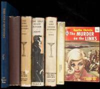 Six volumes of golf murder mysteries, plus one reference work