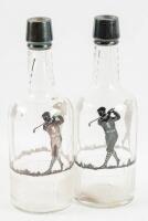 Pair of etched glass bottles with sterling silver overlays of a golfer