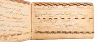 Manuscript book of musical lines, notes, and lyrics from various short songs and tunes