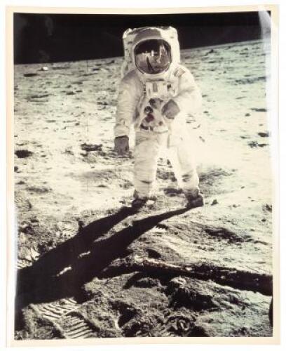 "Bent-arm" photograph of Buzz Aldrin on the moon, with Neil Armstrong, the photographer, reflected in his visor along with the lunar module