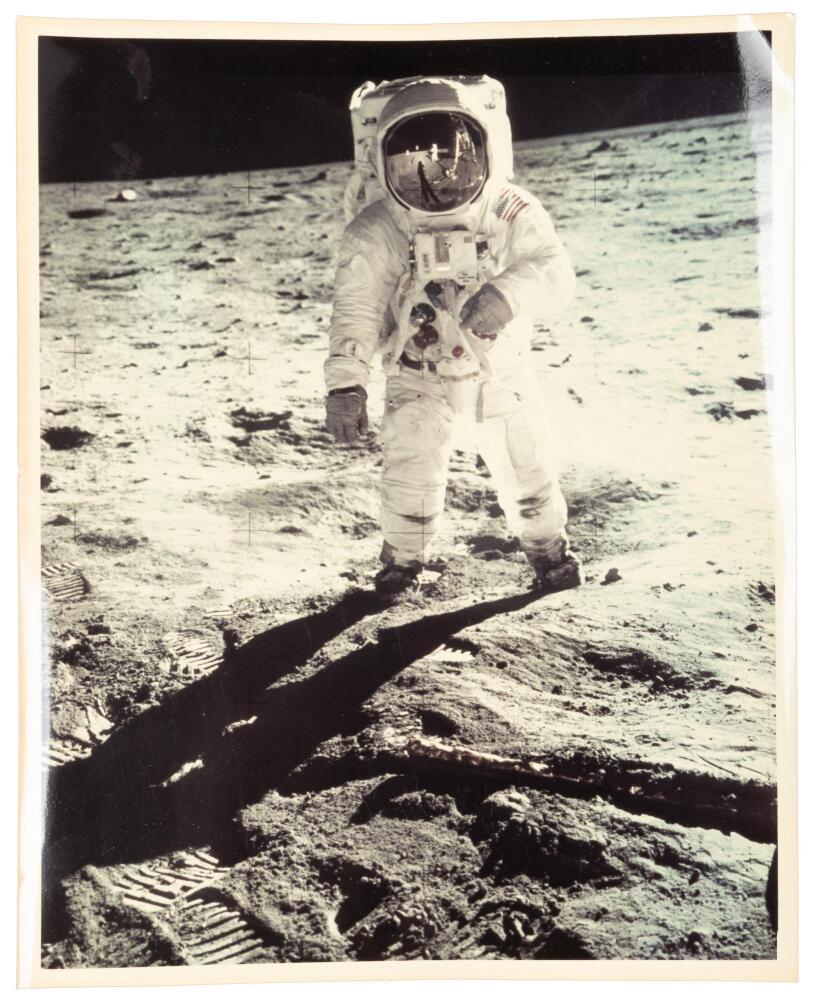 Bent-arm photograph of Buzz Aldrin on the moon, with Neil Armstrong ...