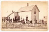 Cabinet card with large gathering of people at E. B. Light's Rustic Cottage