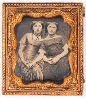 Daguerreotype portrait of two young girls seated and holding hands
