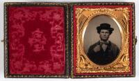 Tintype portrait of gentleman in broad brimmed hat, hand lightly grasping coat lapel