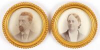 Two circular Opalotype portraits of a man and woman housed in metal gold colored circular frames with convex glass