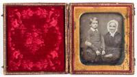 Daguerreotype of grandson standing next to seated grandmother holding glasses in her hand