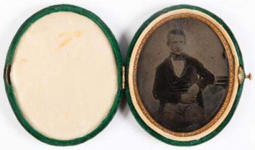 Oval tintype of young gentleman housed in oval green velvet case